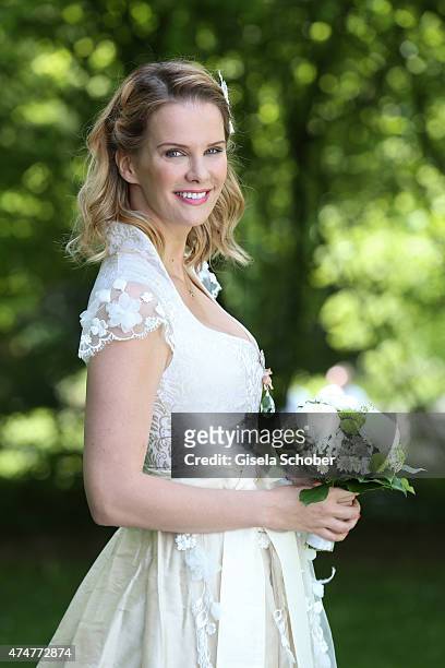 Monica Ivancan, wearing a wedding dirndl by Astrid Soell, poses during a photo session on May 11, 2015 in Munich, Germany.
