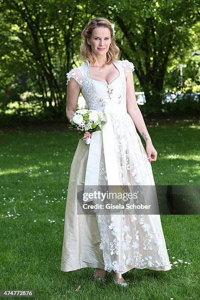 Monica Ivancan, wearing a wedding dirndl by Astrid Soell, poses during a photo session on May 11, 2015 in Munich, Germany.