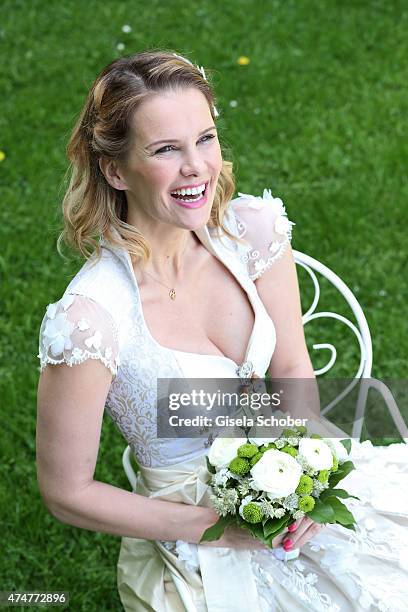 Monica Ivancan, wearing a wedding dirndl by Astrid Soell, poses during a photo session on May 11, 2015 in Munich, Germany.