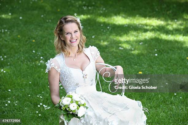 Monica Ivancan, wearing a wedding dirndl by Astrid Soell, poses during a photo session on May 11, 2015 in Munich, Germany.