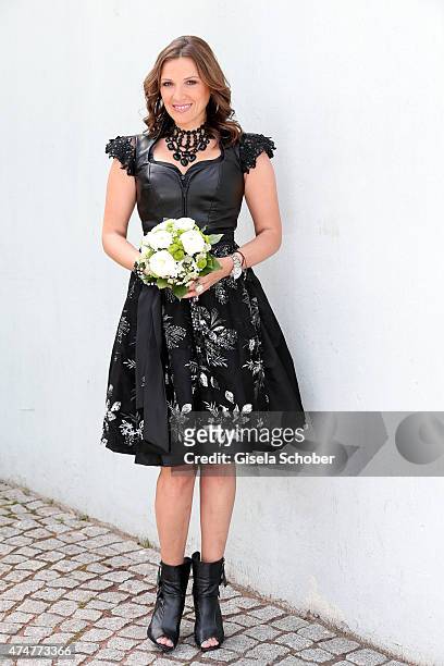 Simone Ballack, wearing a dirndl by Astrid Soell, hair accesssoires by 'Schoenmich', jewellery by 'sweet deluxe', poses during a photo session on May...