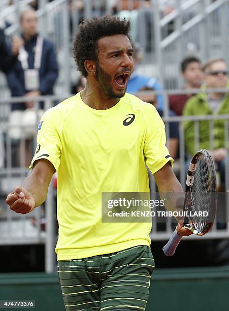 France's Maxime Hamou celebrates after winning a point against Poland's Jerzy Janowicz during the men's first round of the Roland Garros 2015 French...