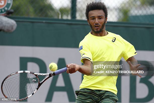 France's Maxime Hamou returns the ball to Poland's Jerzy Janowicz during the men's first round of the Roland Garros 2015 French Tennis Open in Paris...
