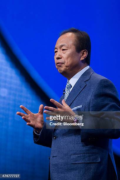 Shin Jong-Kyun, chief executive officer of Samsung Electronics Co., wears a Galaxy Gear Fit device whilst speaking during the company's news...