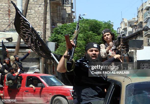 Fighters from Al-Qaeda's Syrian affiliate Al-Nusra Front drive in the northern Syrian city of Aleppo flying Islamist flags as they head to a...