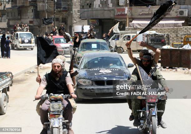 Fighters from Al-Qaeda's Syrian affiliate Al-Nusra Front drive in the northern Syrian city of Aleppo flying Islamist flags as they head to a...