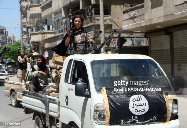 Fighters from Al-Qaeda's Syrian affiliate Al-Nusra Front drive in armed vehicles in the northern Syrian city of Aleppo as they head to a frontline,...