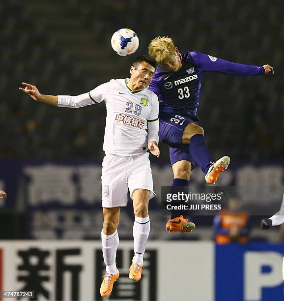 Japan's Sanfrecce Hiroshima defender Tsukasa Shiotani and China's Beijing Guoan forward Shao Jiayi fight for the ball during the AFC champions league...