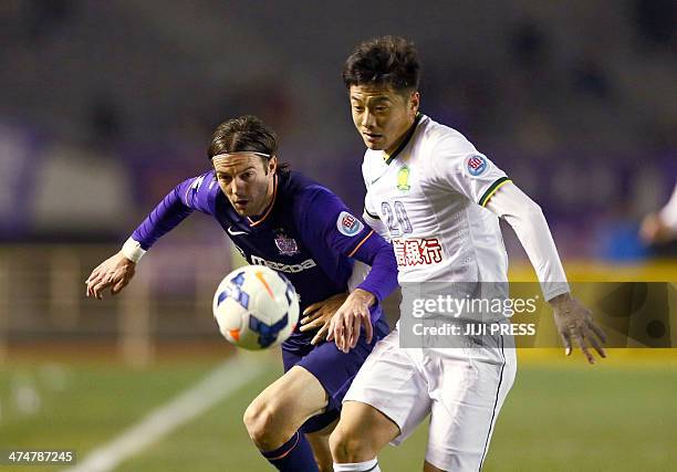 Japan's Sanfrecce Hiroshima midfielder Mihael Mikic and China's Beijing Guoan midfielder Zhang Xinxin fight for the ball during the AFC champions...