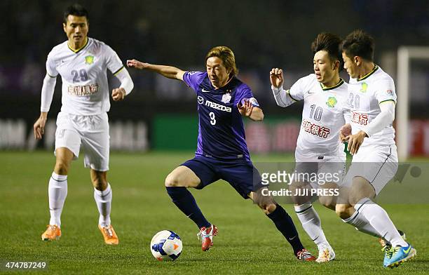 Japan's Sanfrecce Hiroshima forward Naoki Ishihara dribbles the ball while China's Beijing Guoan players Shao Jiayi , Zhang Xizhe and Zhang Xinxin...
