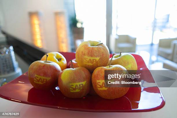 The SAP AG company logo sits on branded eating apples inside the business-software maker's headquarters in Walldorf, Germany, on Monday, Feb. 24,...