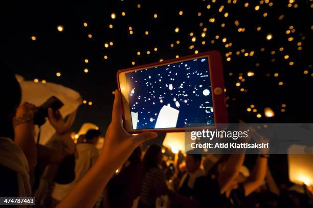 People photograph and video thousands of Khom Lois during the Yi Peng Festival at Lanna Dhutanka.