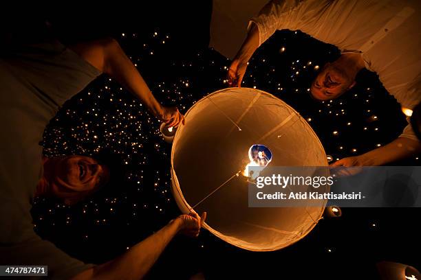Foreign tourists launch a Khom Loi during the Yi Peng Festival at Lanna Dhutanka.