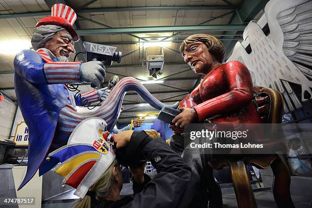 Member of the carneval club 'MCV' takes picture of the a Carnival parade float satirizing German Chancellor Angela Merkel under the motto 'The Spy...