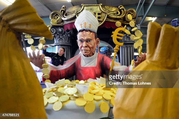 Worker Michelle makes final touches to a Carnival parade float satirizing the bishop Franz Peter Tebartz-van Elst under the motto "Living like God in...