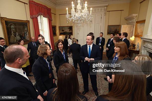 British Prime Minister David Cameron speaks with members of the Winter Olympic medal winning team at 10 Downing Street on February 25, 2014 in...