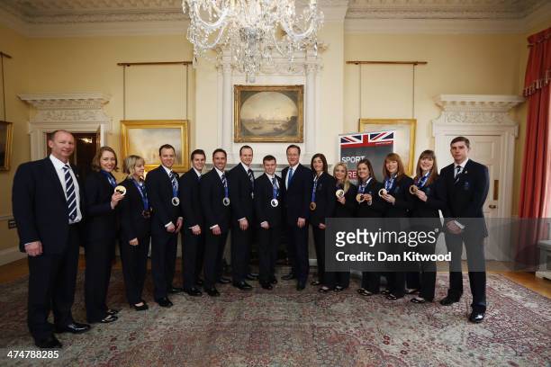Great Britains Winter Olympic Medalists pose with their medals with Britain's Prime Minister David Cameron at 10 Downing Street on February 25, 2014...