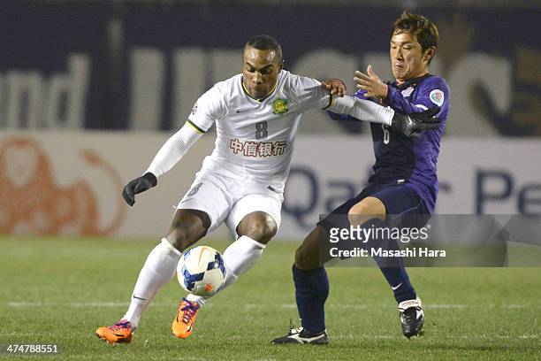 Joffre Davis Guerron Mendez of Beijing Guoan and Toshihiro Aoyama of Sanfrecce Hiroshima compete for the ball during the AFC Champions League match...