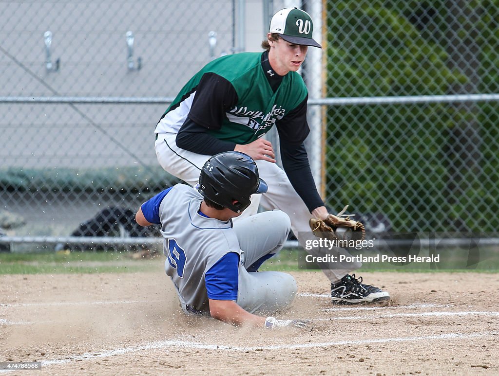 Old Orchard Beach player Mason Beaudoin slides safe into home while