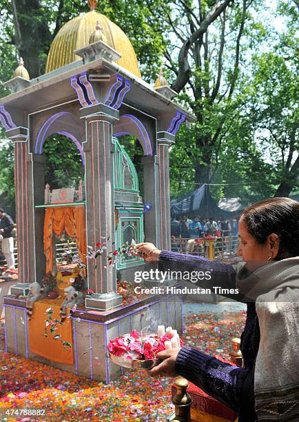 Kashmiri pandit devotee offer flowers to the goddess during the annual Hindu festival at the Kheer Bhawani Temple at Tulla Mulla Ganderbal on May 26,...