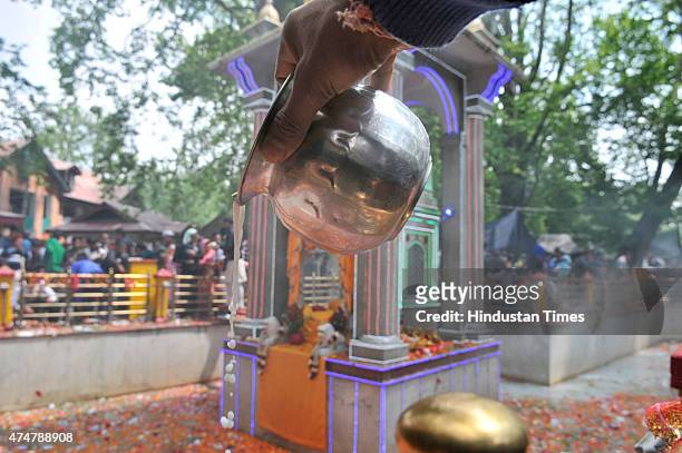 Kashmiri pandit devotee pours milk into a sacred spring during the annual Hindu festival at the Kheer Bhawani Temple at Tulla Mulla Ganderbal on May...