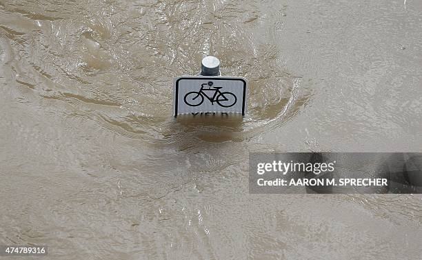 Water is seen at the top of a sign along a bike path near Memorial Drive in Houston, Texas on May 26, 2015. Heavy rains throught Texas put the city...