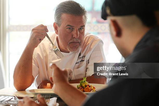 Chef Richard Sandoval talks with Tamayo chef Oscar Padilla about the dish that his is taste testing for quality Friday, May 22, 2015 at Tamayo in...