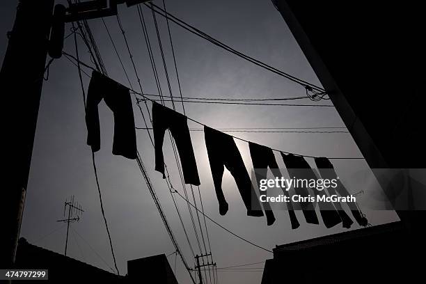 Jeans are seen hanging from powerlines above Jeans Street in Kojima district on February 25, 2014 in Kurashiki, Japan. Kojima is a small seaside...