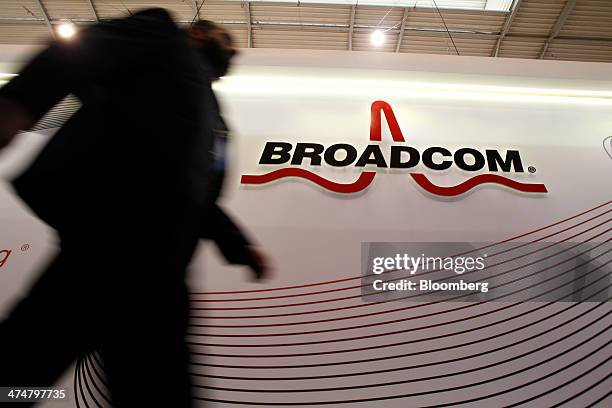 An attendee passes the Broadcom Corp. Pavilon on day two of the Mobile World Congress in Barcelona, Spain, on Tuesday, Feb. 25, 2014. Top...