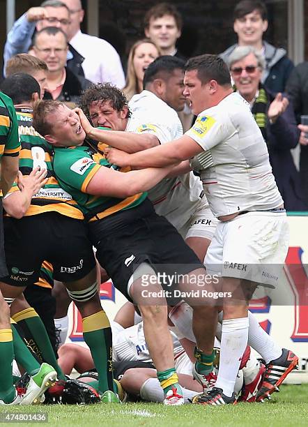 Dylan Hartley, the Northampton Saints captain tustles with Jamie George and Jacques Burger, during the Aviva Premiership play off semi final match...