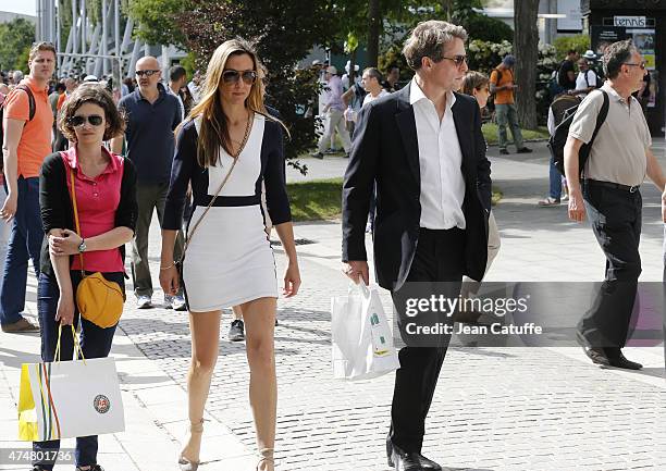 Hugh Grant and Anna Elisabet Eberstein attend day 1 of the French Open 2015 held at Roland Garros stadium on May 24, 2015 in Paris, France.