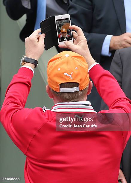 Boris Becker, coach of Novak Djokovic takes a selfie with the Center Court in the background during day 3 of the French Open 2015 at Roland Garros...