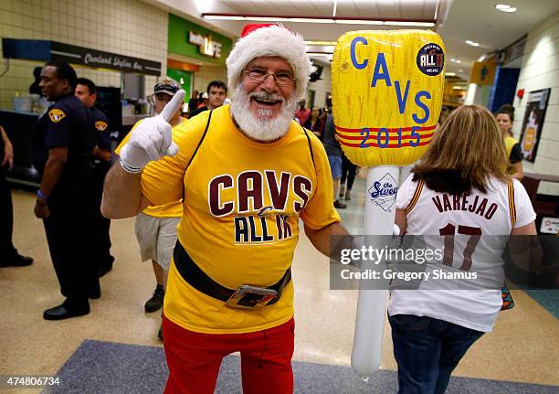 Cleveland Cavaliers fan dressed as Santa Claus holds an inflatable broom before Game Four of the Eastern Conference Finals against the Atlanta Hawks...