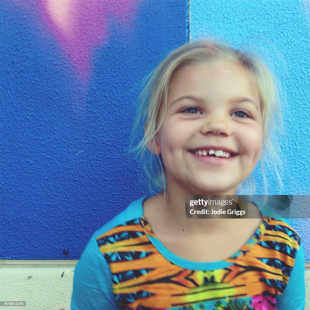 Portrait of young girl with wobbly tooth