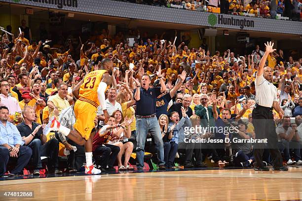 LeBron James of the Cleveland Cavaliers dunks the ball and the fans react after the play against the Atlanta Hawks at the Quicken Loans Arena During...