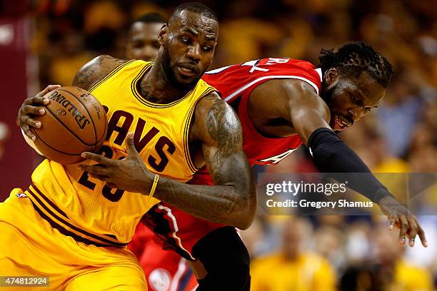 LeBron James of the Cleveland Cavaliers battles for the ball with DeMarre Carroll of the Atlanta Hawks in the first quarter during Game Four of the...