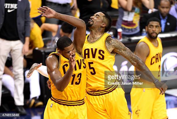 Tristan Thompson and J.R. Smith of the Cleveland Cavaliers react after a dunk by Thompson in the third quarter against the Atlanta Hawks during Game...