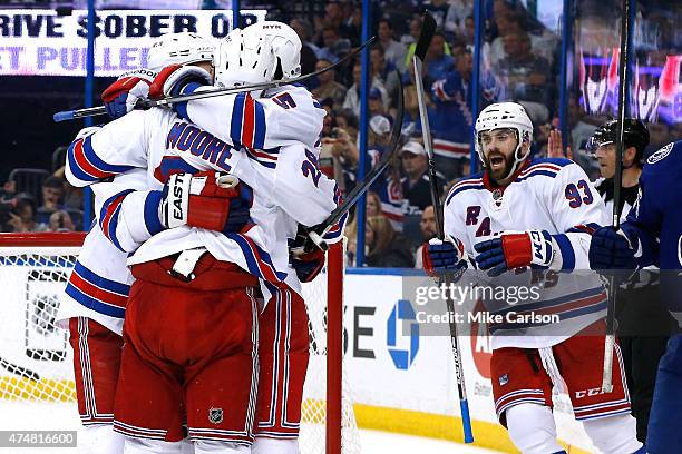 Miller of the New York Rangers celebrates with his teammates after scoring a goal against Ben Bishop of the Tampa Bay Lightning during the third...