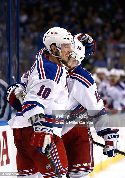 Derick Brassard of the New York Rangers celebrates with teammate J.T. Miller after scoring a goal against the Tampa Bay Lightning during the third...