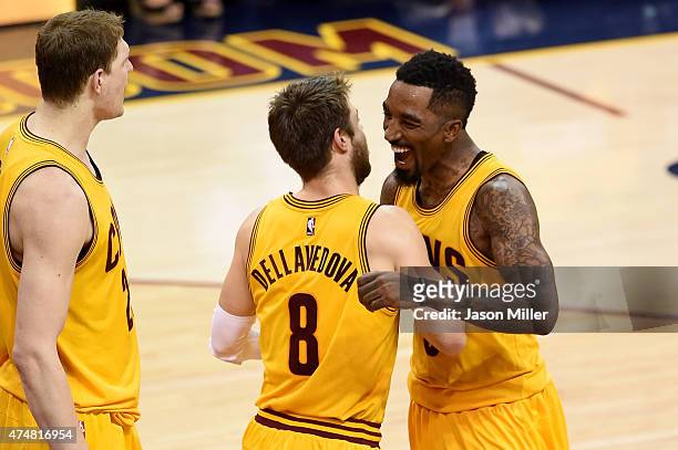 Matthew Dellavedova and J.R. Smith of the Cleveland Cavaliers celebrate after a play in the fourth quarter against the Atlanta Hawks during Game Four...