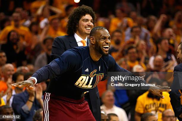 LeBron James and Anderson Varejao of the Cleveland Cavaliers react on the bench in the fourth quarter against the Atlanta Hawks during Game Four of...