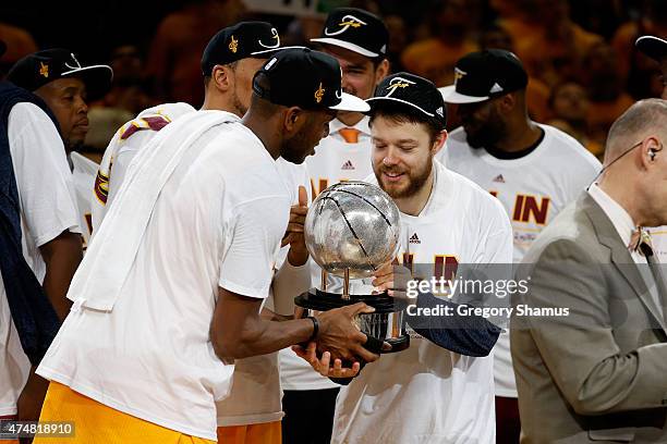 James Jones and Matthew Dellavedova of the Cleveland Cavaliers hold the trophy after defeating the Atlanta Hawks during Game Four of the Eastern...