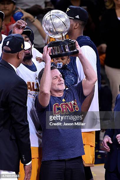 Cleveland Cavaliers owner Dan Gilber holds up the trophy after defeating the Atlanta Hawks during Game Four of the Eastern Conference Finals of the...