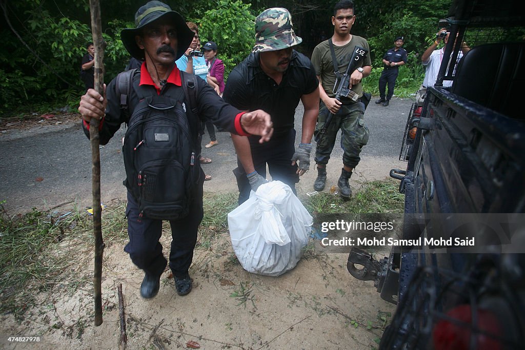 Malaysian Officials Retrieve Bodies From Mass Grave Sites