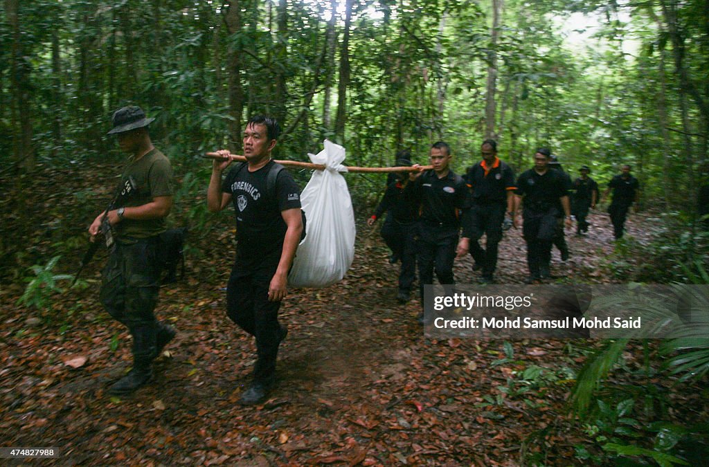 Malaysian Officials Retrieve Bodies From Mass Grave Sites