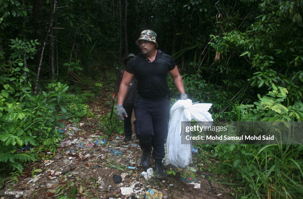 Malaysian Officials Retrieve Bodies From Mass Grave Sites