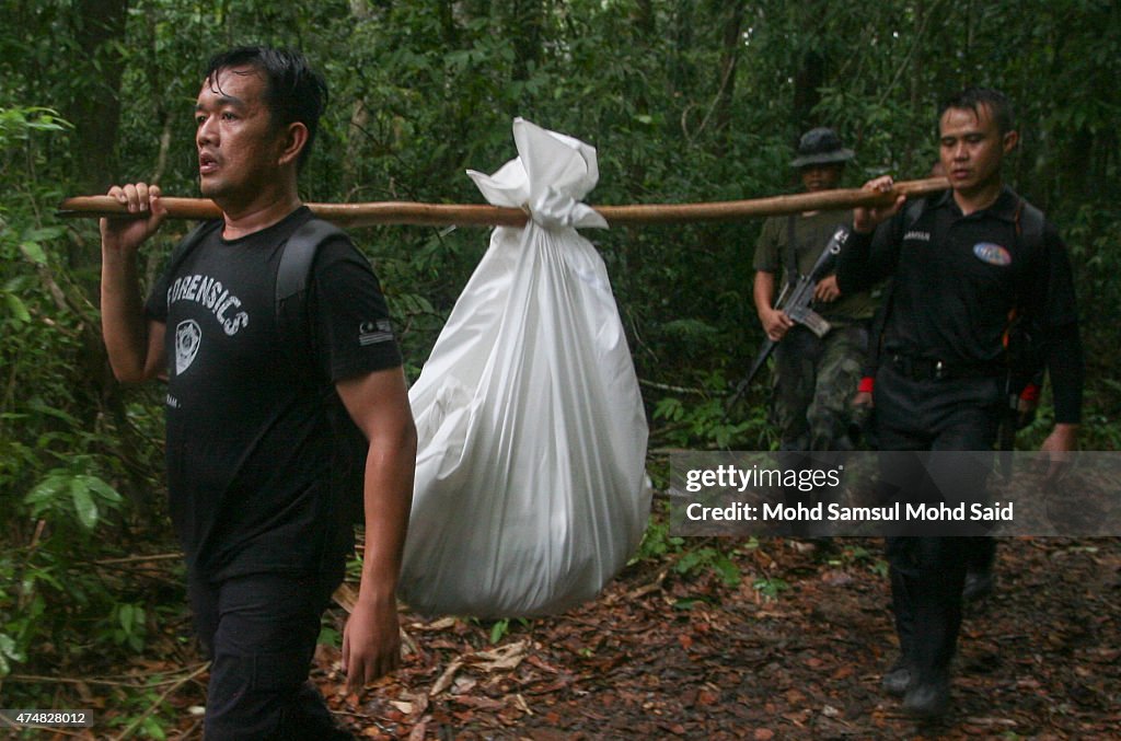 Malaysian Officials Retrieve Bodies From Mass Grave Sites