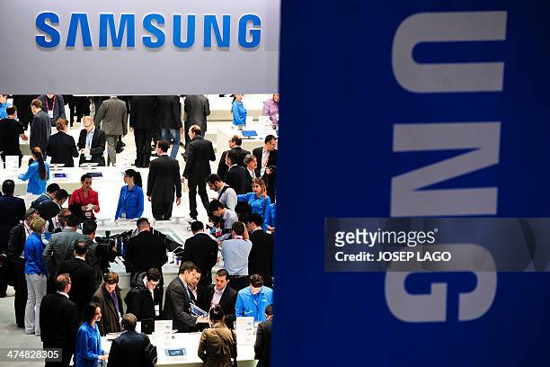 Visitors look at Samsungs devices in Barcelona on February 25 on the second day of the 2013 Mobile World Congress. The 2014 Mobile World Congress,...