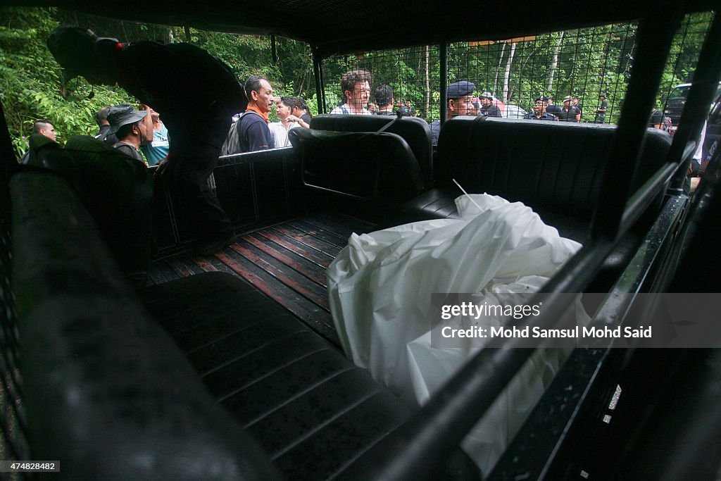 Malaysian Officials Retrieve Bodies From Mass Grave Sites