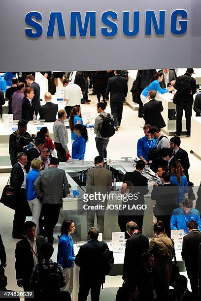 Visitors look at Samsungs devices in Barcelona on February 25 on the second day of the 2013 Mobile World Congress. The 2014 Mobile World Congress,...